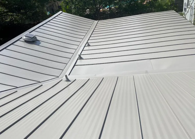 Solar attic fan installed on a metal roof for Roof Ventilation in Miami